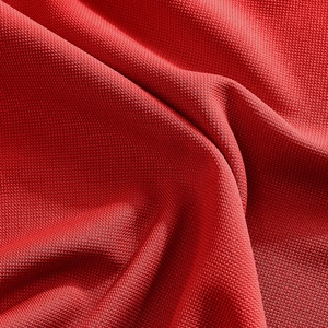 Close-up of red quick-dry polo shirt fabric showing breathable twill texture and soft drape