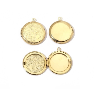 Detailed view of golden round locket with floral relief and polished mirror finish