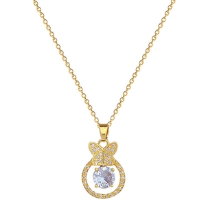 Luxurious gold butterfly pendant necklace with sparkling crystals on a white background