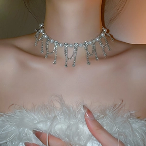 Close-up of pearl choker necklace with sparkling rhinestone tassel detail and elegant finish