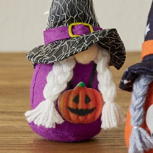 Handcrafted Halloween gnome with purple felt body, witch hat and pumpkin detail