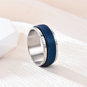 Detailed macro shot of a frosted blue spinning meditation ring made of titanium steel