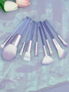 Detail of 9-piece makeup brush set with purple gradient bristles and clear striped handles