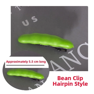 Detail view of a 5.5cm green pea pod hair clip with black metal alligator clip attachment