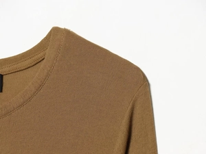 Close-up of brown lace-up t-shirt showing ribbed knit texture and round neckline details
