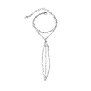 Detailed view of silver multi-layer chain hand harness with rhinestones and pearl accents