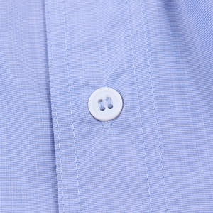 Detailed macro view of light blue striped shirt fabric with a white four-hole button