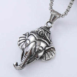 Close-up of vintage silver elephant head pendant with detailed metallic texture and antique finish
