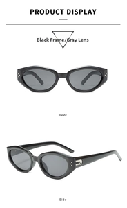 Detail view of black oval sunglasses featuring silver dot accents and metallic temple decor