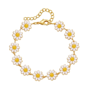 Bohemian gold chain bracelet with eleven white daisy flower charms and adjustable clasp