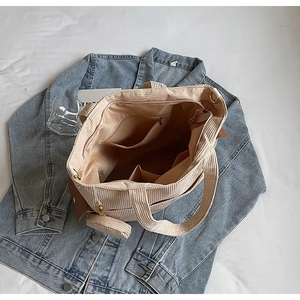 Detailed interior view of corduroy tote bag showing multiple storage pockets and compartments