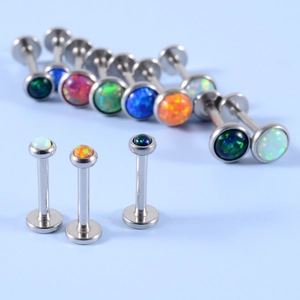 Macro shot of stainless steel labret studs with colorful synthetic opal stone inlays
