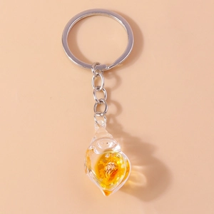 Macro shot of seashell keychain with natural conch shell in transparent resin pendant