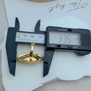 Detailed measurement of large gold oval flower ring face showing 33.5mm width dimension