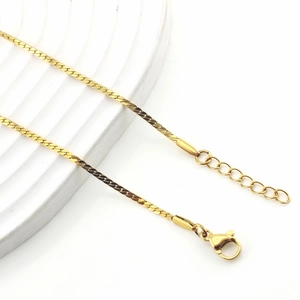 Macro shot of a flat gold snake chain necklace with lobster clasp and extension link