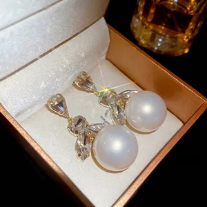 Elegant gold pearl earrings with sparkling rhinestones in a luxury gift box