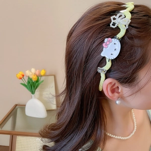 Detail of light green fabric headband featuring Hello Kitty charm and white beaded bow
