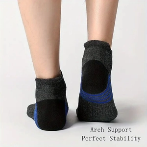 Detail of athletic ankle sock featuring arch support and stability zones in grey and blue