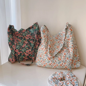 Close-up of quilted floral tote bags and matching hair scrunchies in two pastel colors