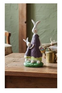 Detailed close-up of rabbit mother and baby resin figurines in a rustic farmhouse style