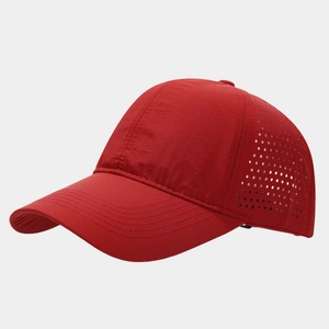 Detail of red quick-dry baseball cap featuring laser-cut ventilation holes for breathability