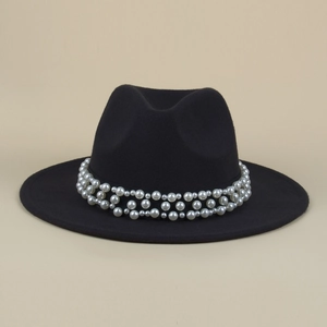 Detail of black wool fedora featuring intricate multi-row white pearl decorative band