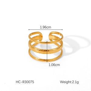 Detailed view of triple-layered gold stainless steel ring with hammered texture detail