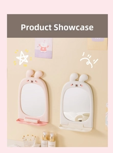 Detail of wall-mounted rabbit vanity mirror with a foldable storage tray for cosmetics