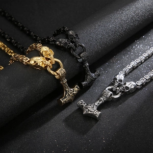 Three Mjolnir necklaces in gold, silver, and black with skull motifs and Byzantine chains