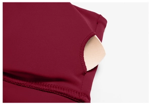 Detail of burgundy yoga bra featuring a built-in pocket for removable padded cups