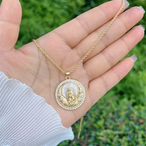 Macro view of 18k gold plated Virgin Mary pendant with pearls and zircon pavé detail