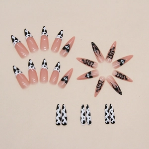 Long pointed almond press-on nails with black cow print and snake art on beige base