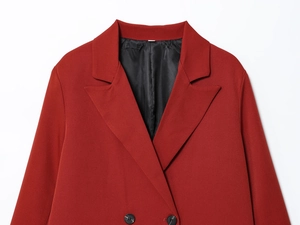 Detailed view of red double-breasted blazer with notch lapel and black silk lining