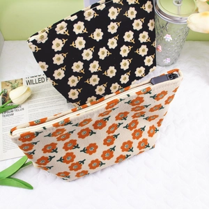 Detailed view of floral corduroy makeup bags with soft texture and vintage patterns