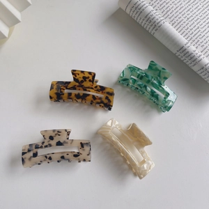 Minimalist acetate hair claws set in amber, marble, emerald green and cream patterns