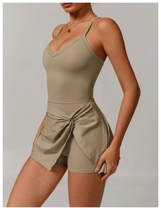 Macro shot of cross-knot hem and layered fabric on khaki green athletic dress