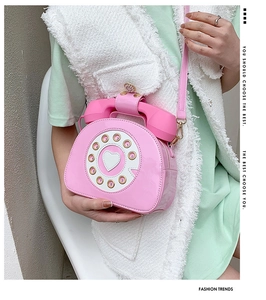 Detail of creative pink patent leather telephone crossbody bag with retro rotary dial