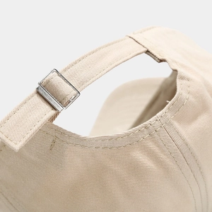 Detail of adjustable metal buckle and stitching on cotton twill baseball cap