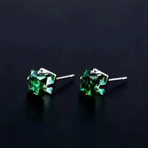 Classic 8mm square green zircon stud earrings with silver claw setting on black background