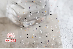 Detailed view of KX-043 terrazzo pattern nail art stickers on elegant lace background