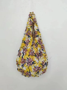 Detail of yellow floral stretch tote bag featuring unique textured bubble shrink fabric