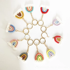 Detail of 10 handmade knitted rainbow keychains with colorful cotton rope and gold rings