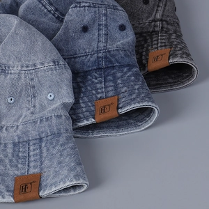 Vintage washed denim bucket hats in multiple colors with leather logo patch detail