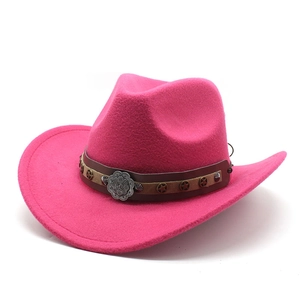 Detail of rose red cowboy hat featuring brown band and decorative metal star rivets