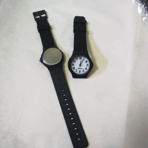 Front and back view of silent black quartz watch showing dial and resin strap