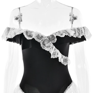 Close-up of black backless bodysuit with white lace ruffles and floral mesh details