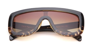 Detail view of large aviator sunglasses with gradient brown lenses and hand-polished frame