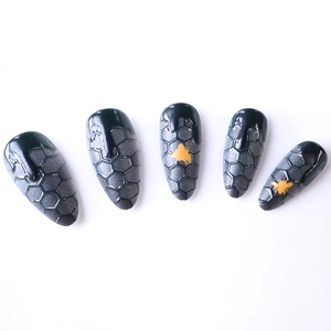 Almond-shaped black honeycomb nails with yellow bee art and 3D fluid drip effect