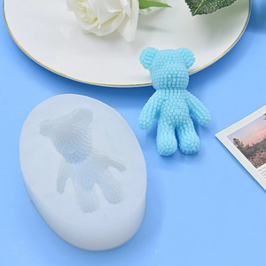 Detail of 3D block bear silicone mold with blue resin teddy bear on artistic props