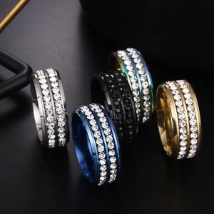 Detail shot of double-row cubic zirconia rings in silver, blue, black, gold and rainbow finish